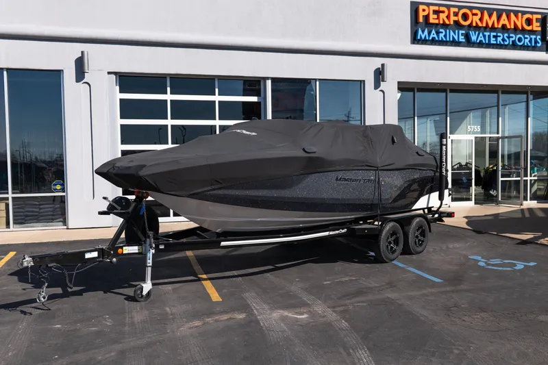Slide: The Image of 2023 MasterCraft NXT22 boat covered on trailer at Performance Marine Watersports dealership. - 30