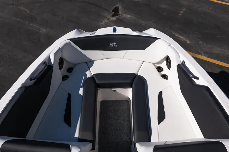 Slide: The Image of 2023 MasterCraft NXT22 boat interior with sleek black and white seating design. - 8