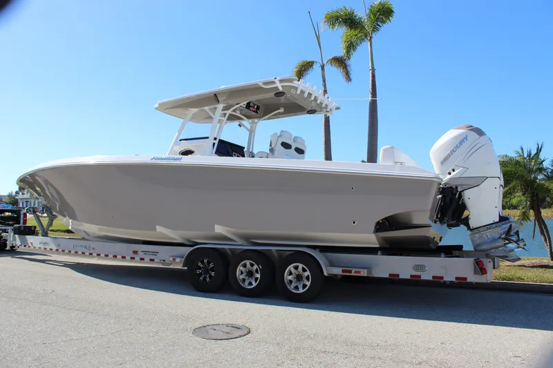 Slide: The Image of 2018 Fountain 38 CC Tournament Edition boat on trailer, palm trees in background. - 13