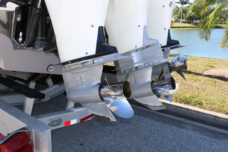 Slide: The Image of 2018 Fountain 38 CC Tournament Edition boat propellers by a lakeside. - 17