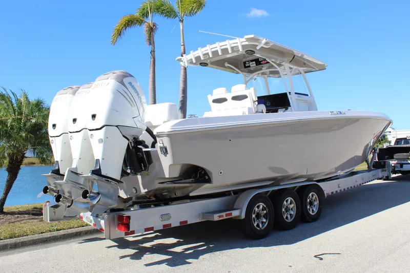 Slide: The Image of 2018 Fountain 38 CC Tournament Edition boat on trailer, triple engines, palm trees in background. - 21