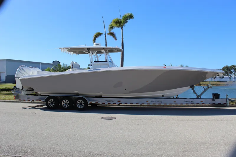 Slide: The Image of 2018 Fountain 38 CC Tournament Edition boat on trailer, parked near water. - 38