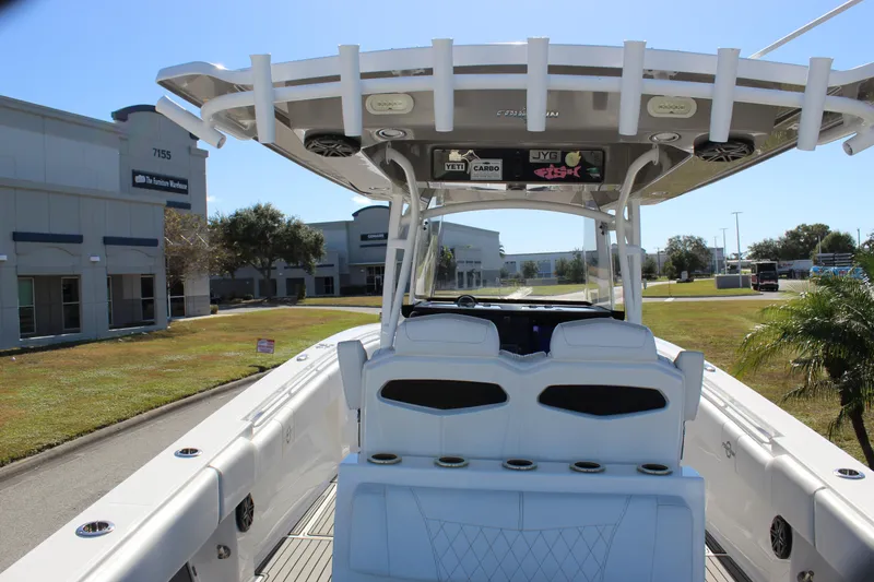 Slide: The Image of 2019 Fountain 38 CC Tournament Edition boat at a marina with buildings in the background. - 39