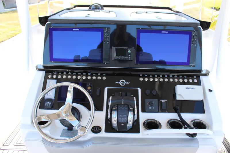 Slide: The Image of 2019 Fountain 38 CC Tournament Edition boat dashboard with dual Simrad displays and steering wheel. - 41
