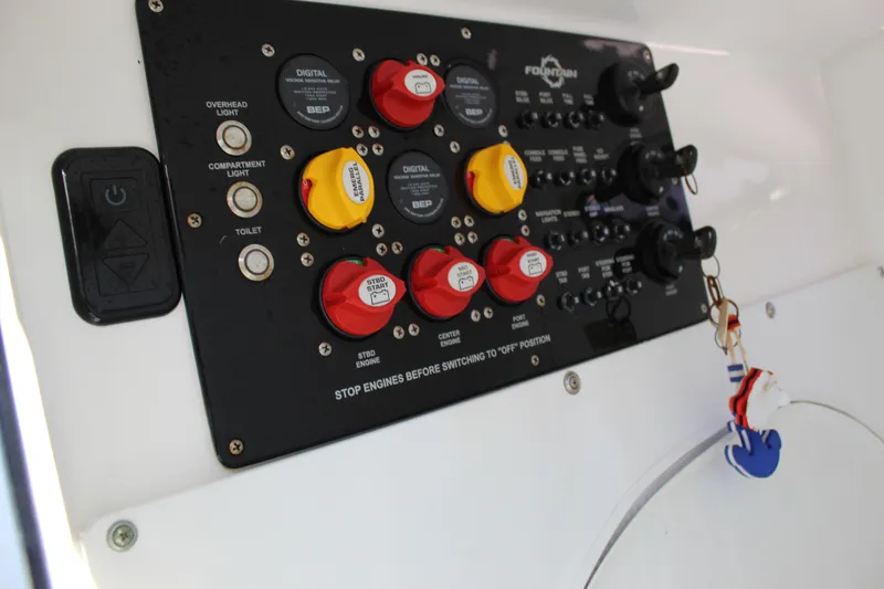 Slide: The Image of Control panel of 2019 Fountain 38 CC Tournament Edition boat with switches and keychain. - 48
