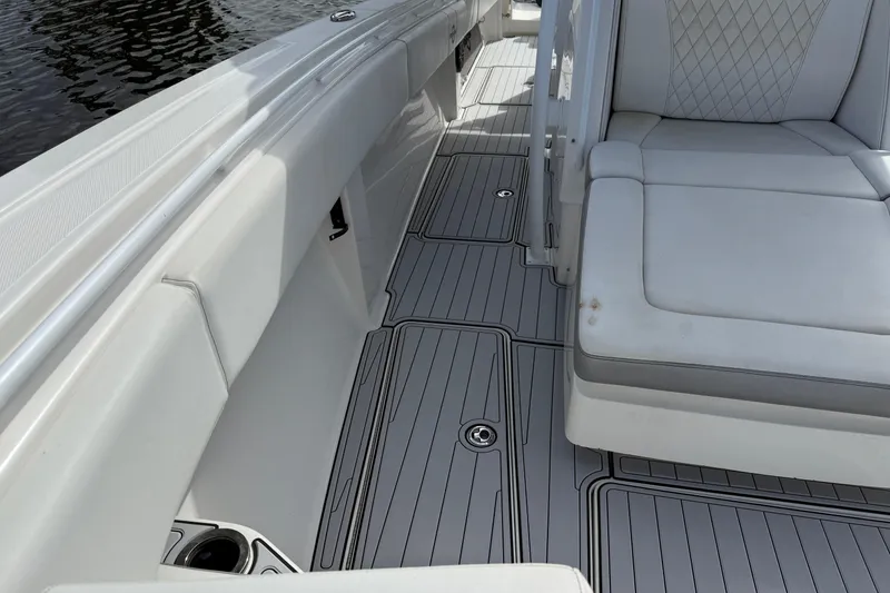 Slide: The Image of 2019 Fountain 38 CC Tournament Edition boat interior with cushioned seating and sleek flooring. - 49