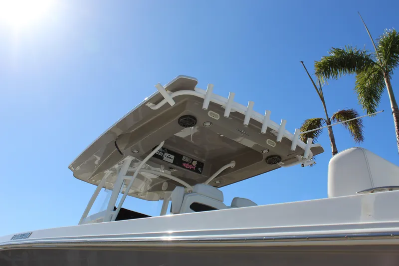 Slide: The Image of 2018 Fountain 38 CC Tournament Edition boat under clear blue sky with palm trees. - 5