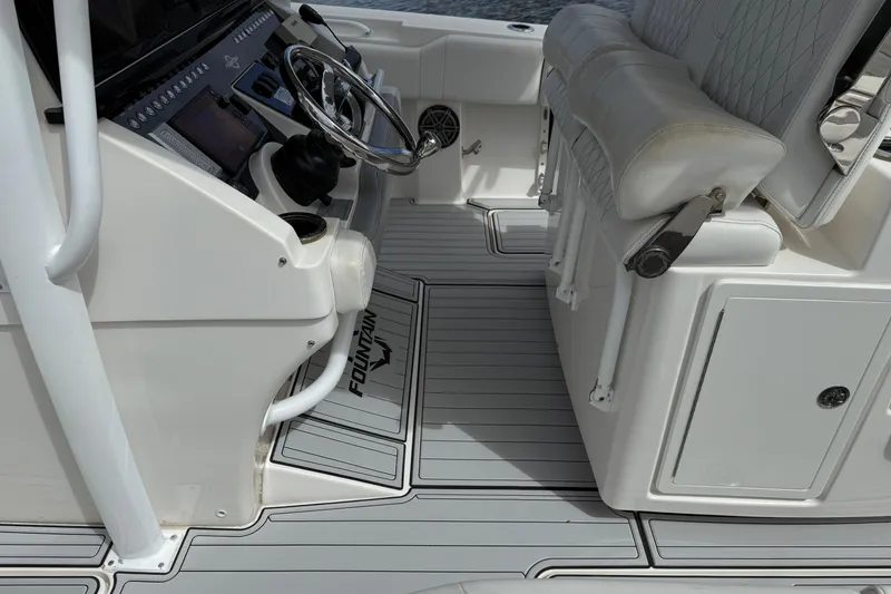 Slide: The Image of 2019 Fountain 38 CC Tournament Edition boat cockpit with steering wheel and seating. - 53