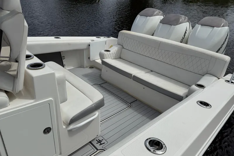 Slide: The Image of 2019 Fountain 38 CC Tournament Edition boat interior with seating and triple Mercury engines. - 54