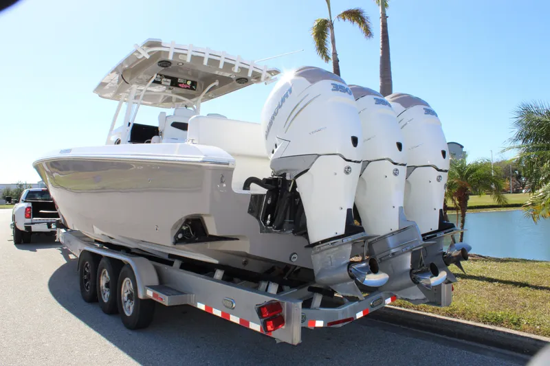 Slide: The Image of 2018 Fountain 38 CC Tournament Edition boat on trailer with triple Mercury engines. - 6