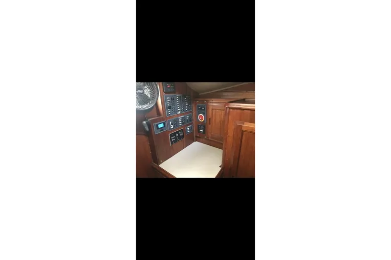 Slide: The Image of Interior of 1977 Ericson 36 C sailboat with control panel and wooden cabinetry. - 12