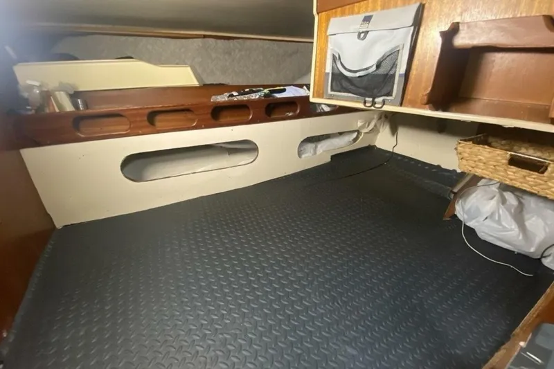 Slide: The Image of Interior cabin of a 1977 Ericson 36 C sailboat with storage and wooden accents. - 14