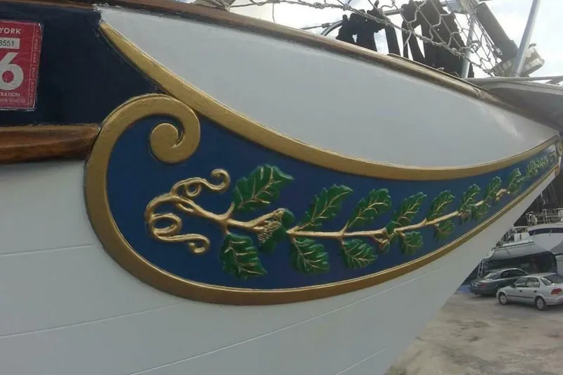 Slide: The Image of Decorative detail on 1977 Ericson 36 C sailboat, featuring gold and green leaf design. - 26