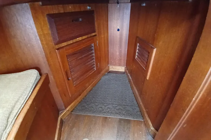 Slide: The Image of Wooden interior of 1977 Ericson 36 C sailboat, featuring cabinets and a carpeted floor. - 33
