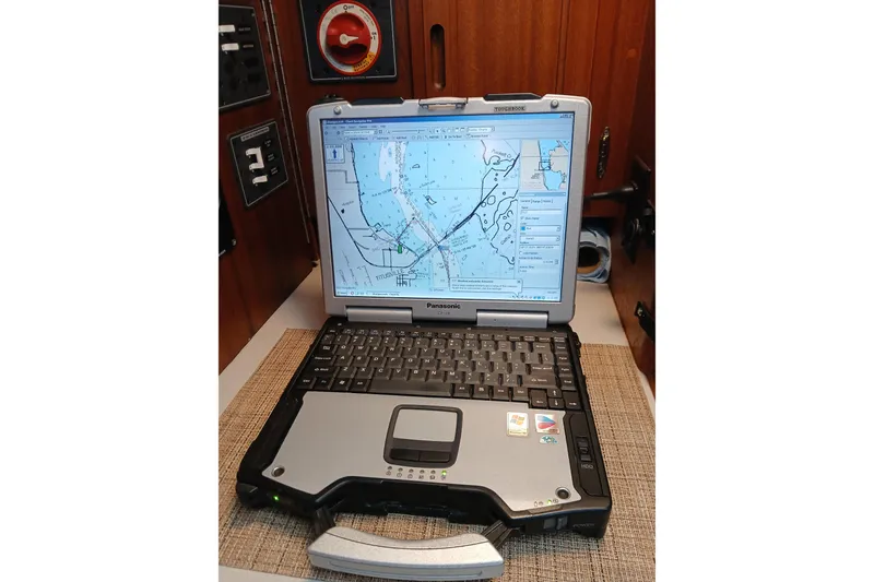 Slide: The Image of Rugged Panasonic laptop displaying nautical chart inside 1977 Ericson 36 C sailboat cabin. - 35