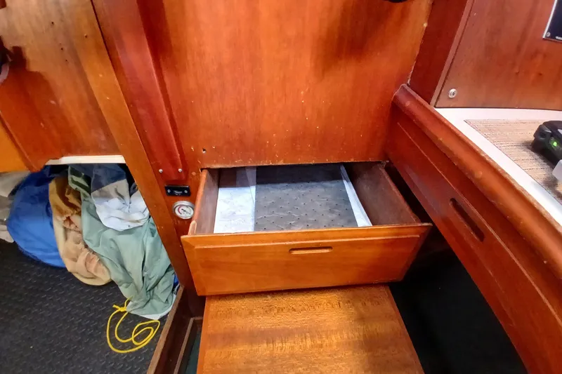 Slide: The Image of Open wooden drawer inside a 1977 Ericson 36 C sailboat cabin. - 36