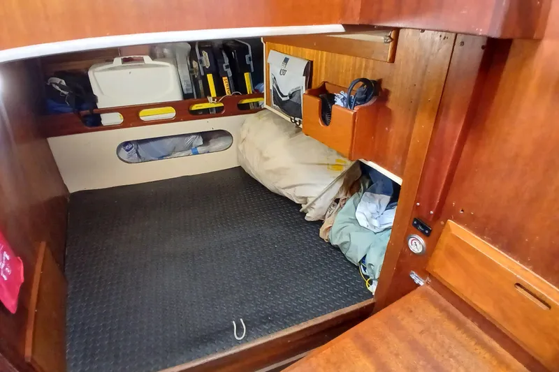 Slide: The Image of Cozy cabin interior of a 1977 Ericson 36 C sailboat with storage and bedding. - 38