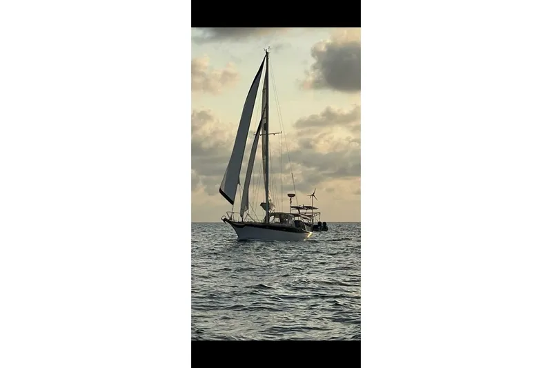 Slide: The Image of Sailing boat Ericson 36 C (1977) on open sea at sunset. - 4