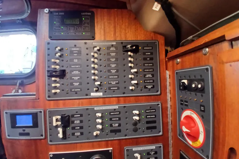 Slide: The Image of Electrical control panel inside a 1977 Ericson 36 C sailboat, featuring switches and gauges. - 40