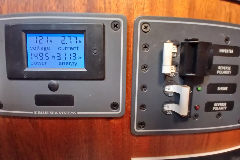 Slide: The Image of Electrical panel on a 1977 Ericson 36 C sailboat, displaying voltage and current readings. - 41