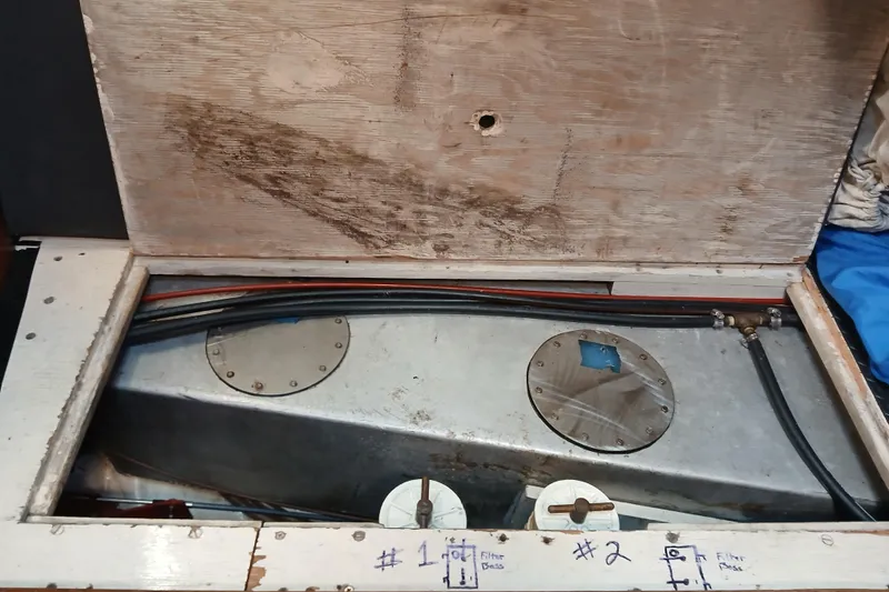 Slide: The Image of Fuel tank compartment of a 1977 Ericson 36 C sailboat, showing hoses and fittings. - 43