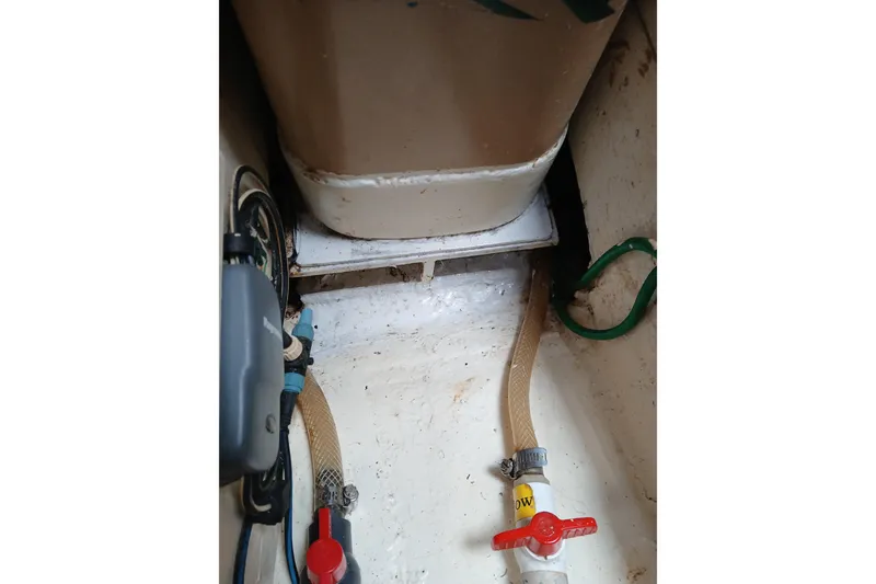 Slide: The Image of Interior of 1977 Ericson 36 C sailboat showing plumbing and storage area. - 52