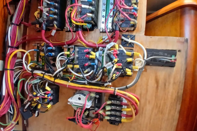 Slide: The Image of Electrical panel with colorful wiring in a 1977 Ericson 36 C sailboat. - 54