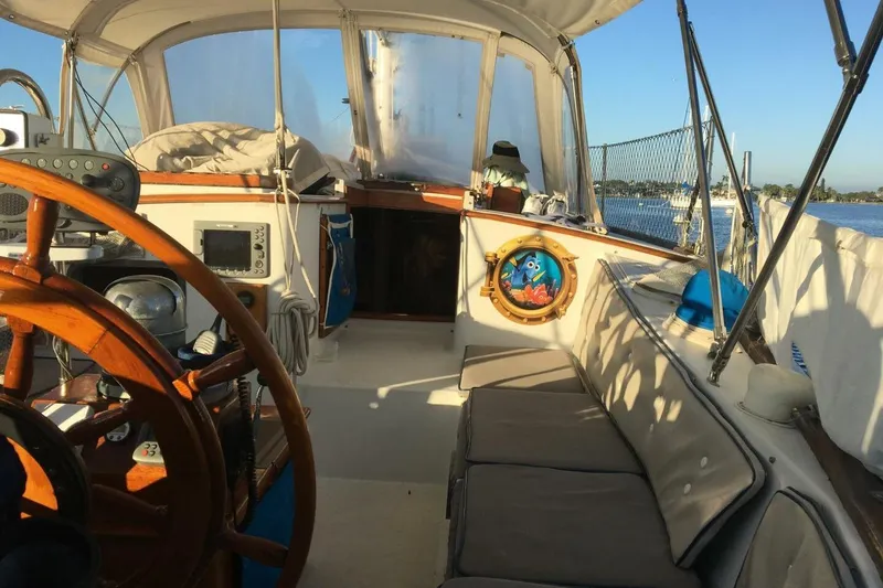 Slide: The Image of Interior view of 1977 Ericson 36 C sailboat cockpit with wooden wheel and seating. - 6