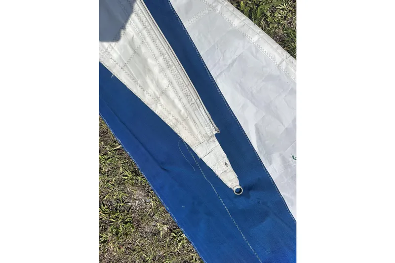 Slide: The Image of Close-up of a blue and white sail from a 1977 Ericson 36 C sailboat. - 68
