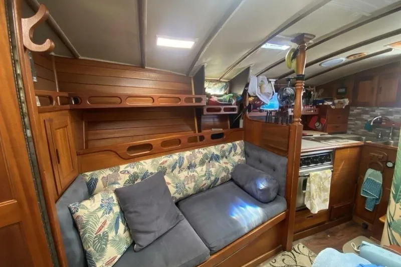 Slide: The Image of Interior of 1977 Ericson 36 C sailboat with cozy seating and wooden cabinetry. - 8