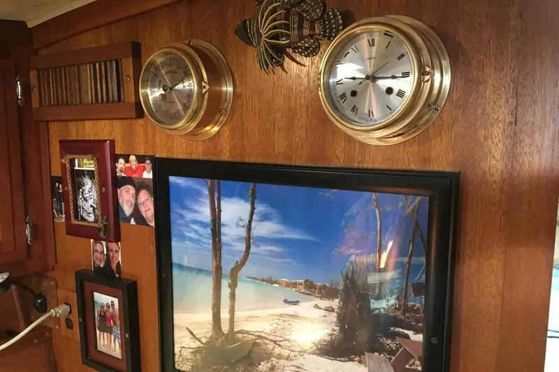 Slide: The Image of Interior of a 1977 Ericson 36 C sailboat with nautical decor and beach photo. - 9