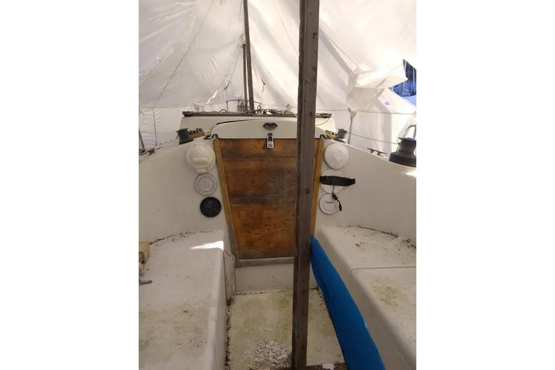 Slide: The Image of 1975 WDS Santana boat interior with wooden panel and white seating. - 11