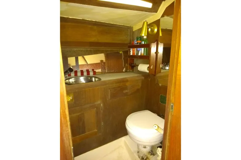 Slide: The Image of Interior of a 1975 Schock Santana yacht with toilet and sink. - 16