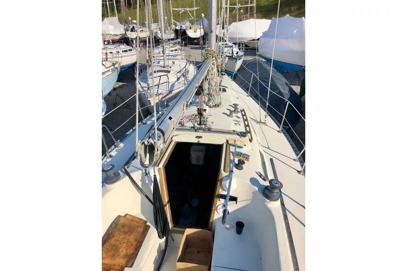 Slide: The Image of 1975 WDS Santana sailboat deck with marina view in background. - 2