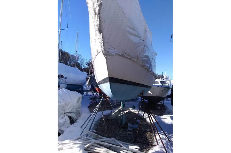 Slide: The Image of 1975 WDS Santana sailboat in winter storage, covered and supported on stands. - 4