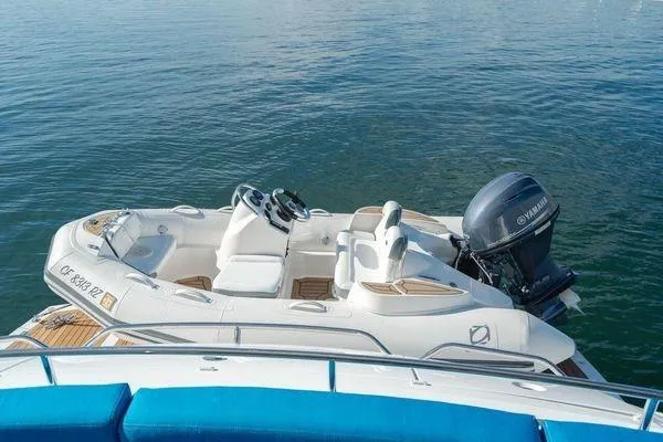Slide: The Image of Sunseeker Manhattan 60 yacht, 2010 model, with Yamaha outboard motor on calm water. - 4