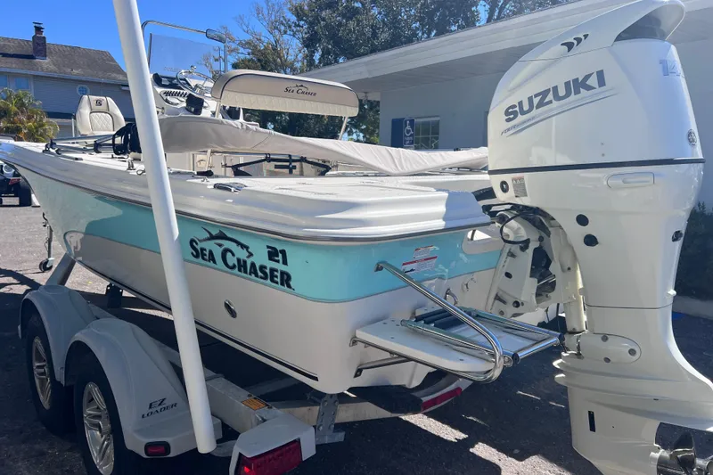 The Image of 2020 Sea Chaser 21 Sea Skiff boat with Suzuki outboard motor on trailer. - 0