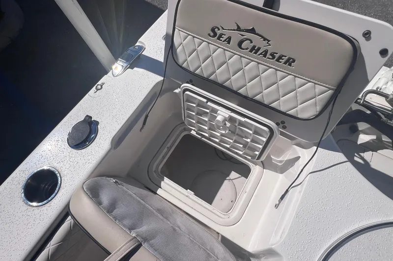 Slide: The Image of 2020 Sea Chaser 21 Sea Skiff boat interior with storage compartment and cup holder. - 11