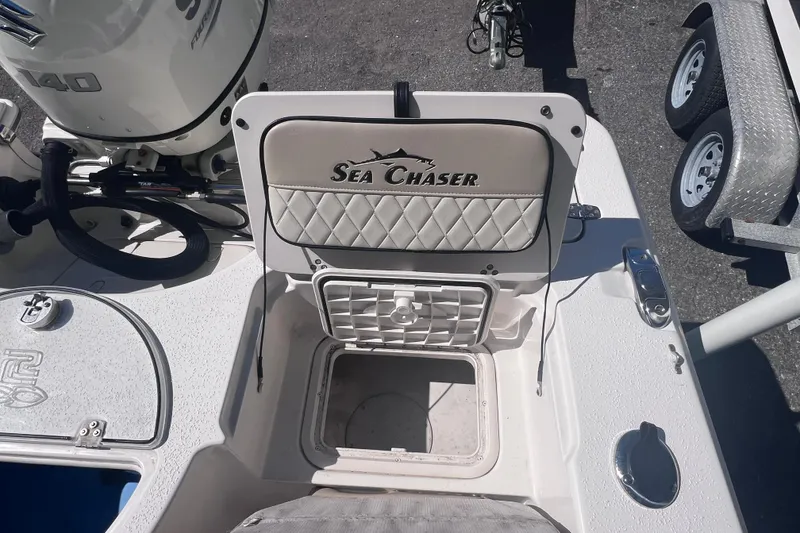 Slide: The Image of 2020 Sea Chaser 21 Sea Skiff boat interior with storage compartment and motor. - 12