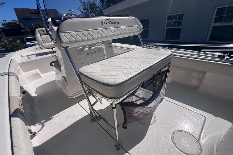 Slide: The Image of 2020 Sea Chaser 21 Sea Skiff boat interior with cushioned seating and storage. - 17