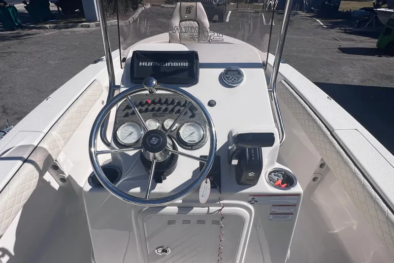 Slide: The Image of 2020 Sea Chaser 21 Sea Skiff boat console with steering wheel and controls. - 18