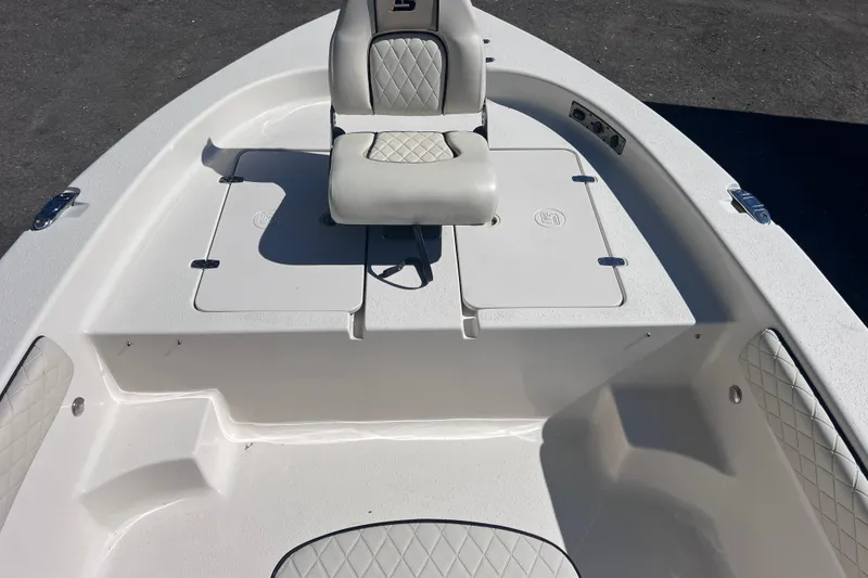 Slide: The Image of 2020 Sea Chaser 21 Sea Skiff boat interior with cushioned seating and storage compartments. - 25