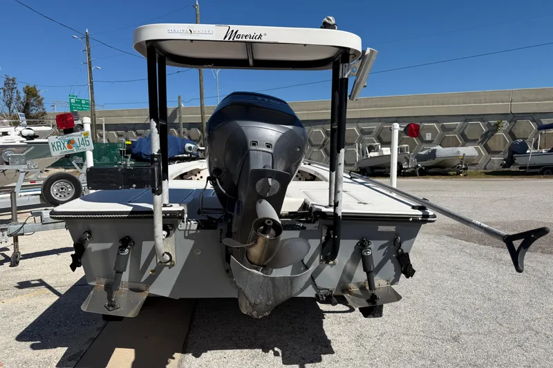Slide: The Image of 2000 Maverick 18 Master Angler boat with outboard motor, parked on a trailer. - 8