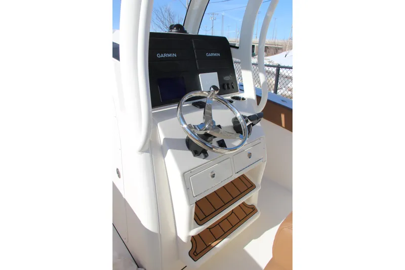 Slide: The Image of 2026 Pioneer 270 Pelagic boat helm with Garmin navigation system and stainless steel steering wheel. - 12