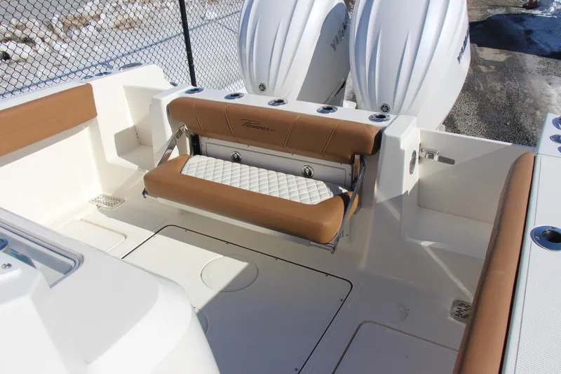 Slide: The Image of 2026 Pioneer 270 Pelagic boat interior with tan seating and dual outboard engines. - 14