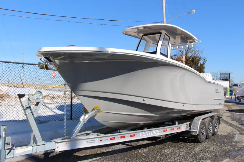 Slide: The Image of 2026 Pioneer 270 Pelagic boat on trailer, displayed outdoors under clear blue sky. - 3