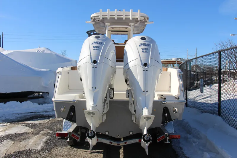 Slide: The Image of 2026 Pioneer 270 Pelagic boat with dual 250 V6 outboard engines, parked outdoors. - 5