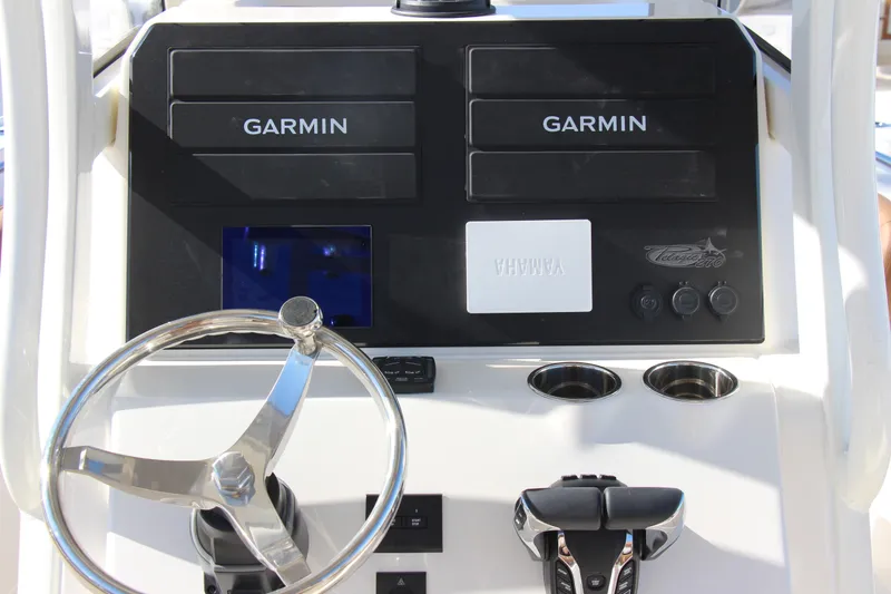 Slide: The Image of Steering console of 2026 Pioneer 270 Pelagic boat with Garmin displays and Yamaha controls. - 7