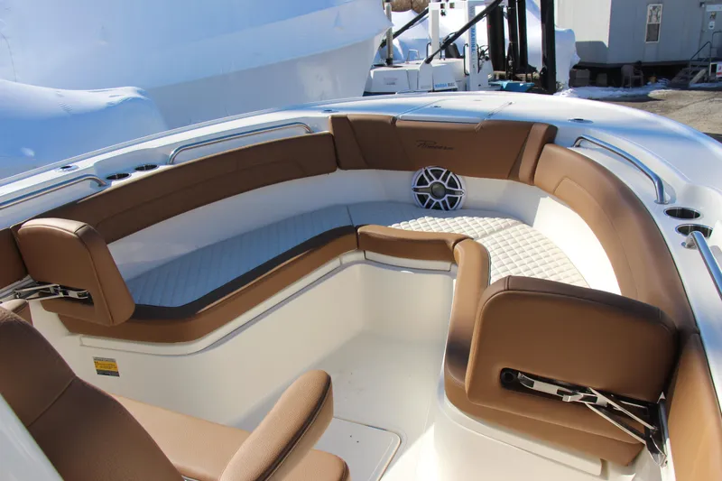 Slide: The Image of 2026 Pioneer 270 Pelagic boat interior with brown cushioned seating and speaker system. - 8