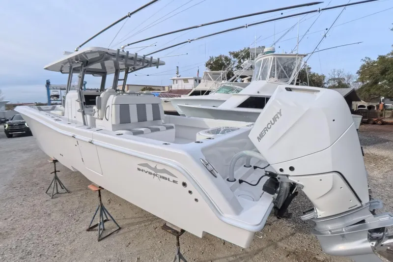 Slide: The Image of 2025 Invincible 39 Open Fisherman boat with Mercury engine, docked outdoors. - 7